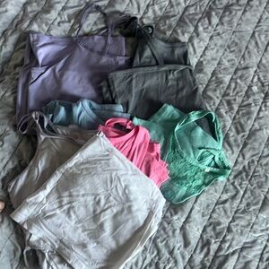 This price is a steal! Pile of random woman’s tanks to wear under things.